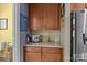 Butler's pantry features a stainless steel refrigerator, custom cabinetry and granite countertops at 125 Snow Fountain Ln, Mooresville, NC 28115