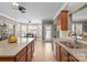 Open kitchen featuring granite countertops, stainless steel appliances, and a view to the dining area at 125 Snow Fountain Ln, Mooresville, NC 28115