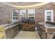 Outdoor kitchen featuring stainless steel appliances, wood storage, and prep area at 125 Snow Fountain Ln, Mooresville, NC 28115