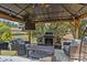 Outdoor living space boasts a fireplace, TV, comfortable seating, and ceiling fan at 125 Snow Fountain Ln, Mooresville, NC 28115