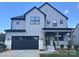 Beautiful new construction home with gray siding, black trim, a front porch, and a two-car garage at 15012 Brownleigh Ln # 30, Huntersville, NC 28078