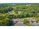 Aerial view of the community near the lake with mature trees at 1504 Harpers Inlet Dr, Lake Wylie, SC 29710