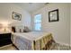 Cozy bedroom with natural light, wood floors and decorative mirror at 1504 Harpers Inlet Dr, Lake Wylie, SC 29710