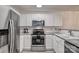Modern kitchen with stainless steel appliances, granite counters, and sleek white cabinets at 1504 Harpers Inlet Dr, Lake Wylie, SC 29710