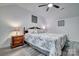 Main bedroom features a ceiling fan, wood floors and decorative wall art at 1504 Harpers Inlet Dr, Lake Wylie, SC 29710