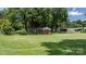 Lush green backyard with a fenced perimeter, featuring mature trees at 151 Third Creek Rd, Statesville, NC 28677