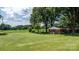 Expansive green backyard featuring a well-maintained lawn and a cozy brick house at 151 Third Creek Rd, Statesville, NC 28677