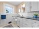 Well-lit bathroom offering granite counters, white tiling and cabinetry, and decorative accents at 151 Third Creek Rd, Statesville, NC 28677