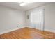 Empty bedroom featuring hardwood floors and a large window with natural light and neutral gray walls at 151 Third Creek Rd, Statesville, NC 28677