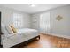 Bright bedroom showcasing hardwood floors, natural light, and neutral wall colors at 151 Third Creek Rd, Statesville, NC 28677