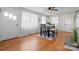 Sunlit dining area with hardwood floors, a modern table set, and large windows offering ample natural light, ideal for meals at 151 Third Creek Rd, Statesville, NC 28677