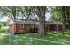 A beautiful brick home with lush green lawn and mature trees on the property at 151 Third Creek Rd, Statesville, NC 28677