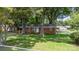 Charming brick home surrounded by mature trees and a well-manicured front lawn at 151 Third Creek Rd, Statesville, NC 28677