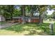Charming brick home with mature trees and a well-manicured front lawn at 151 Third Creek Rd, Statesville, NC 28677