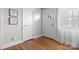 Hallway featuring hardwood floors and two white doorways with natural light from a window at 151 Third Creek Rd, Statesville, NC 28677