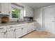 Bright kitchen featuring white cabinetry, durable countertops, and an efficient layout at 151 Third Creek Rd, Statesville, NC 28677