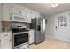 Functional kitchen featuring stainless steel appliances, neutral countertops, and ample storage space at 151 Third Creek Rd, Statesville, NC 28677
