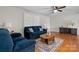 Inviting living room with hardwood floors, a ceiling fan, and comfortable blue upholstered seating at 151 Third Creek Rd, Statesville, NC 28677