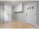 Mud room featuring white cabinetry and linoleum flooring and doorway with window pane accents at 151 Third Creek Rd, Statesville, NC 28677