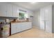 Pantry featuring white cabinetry, a window for natural light, and linoleum flooring at 151 Third Creek Rd, Statesville, NC 28677