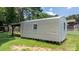 Metal outbuilding with functional window and sliding doors, nestled on a grassy lot at 151 Third Creek Rd, Statesville, NC 28677