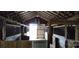 Rustic barn featuring stalls with metal gates, exposed beams, and a weathered warning sign at 1521 N Piedmont Ave, Kings Mountain, NC 28086