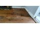 Damaged hardwood floors with stone fireplace remnants on a home needing repairs and renovations at 1521 N Piedmont Ave, Kings Mountain, NC 28086