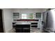 Galley-style kitchen with built-in shelving, stainless refrigerator, and gray countertops offers essential workspace at 1521 N Piedmont Ave, Kings Mountain, NC 28086