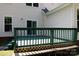 Well-maintained wooden deck with green paint, house siding, and backyard access at 1540 Coatsworth Ln, Rock Hill, SC 29732