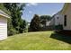Spacious backyard with a well-maintained lawn, trees, and house in the background at 1540 Coatsworth Ln, Rock Hill, SC 29732