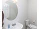 Half bathroom offering a white vanity and a modern, round mirror at 1540 Coatsworth Ln, Rock Hill, SC 29732