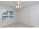 Bedroom featuring a ceiling fan, carpet, window, and a white door to a closet at 1540 Coatsworth Ln, Rock Hill, SC 29732