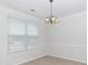 Dining room with white wainscotting and light fixture at 1540 Coatsworth Ln, Rock Hill, SC 29732
