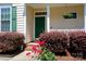 Charming entrance with a green front door, brick steps, and vibrant flower bed at 1540 Coatsworth Ln, Rock Hill, SC 29732