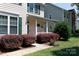 Inviting front porch with beautiful landscaping and colorful flower hanging baskets at 1540 Coatsworth Ln, Rock Hill, SC 29732