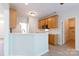 Kitchen with wooden cabinets, white appliances, countertops, and a view to other rooms at 1540 Coatsworth Ln, Rock Hill, SC 29732