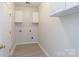 Functional laundry room features overhead cabinets and connections for appliances at 1540 Coatsworth Ln, Rock Hill, SC 29732