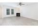 Bright living room features wood-look floors, a fireplace, and lots of natural light at 1540 Coatsworth Ln, Rock Hill, SC 29732