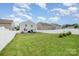 Expansive backyard featuring well-maintained lawn, a white fence, and a patio with outdoor furniture for relaxation and entertainment at 1624 Savory Ln, Charlotte, NC 28216