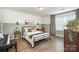 Cozy bedroom featuring a comfortable bed, stylish decor, and a bright window at 1624 Savory Ln, Charlotte, NC 28216