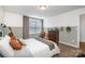 Neutral bedroom featuring a black metal bed frame, wood floors, and neutral-toned decor with stylish decorative touches at 1624 Savory Ln, Charlotte, NC 28216