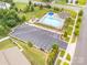 Aerial view of the community pool and recreation area featuring a pool, playground, and ample parking at 1624 Savory Ln, Charlotte, NC 28216