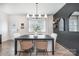 Modern dining room featuring a dark wood table, woven chairs, and stylish decor at 1624 Savory Ln, Charlotte, NC 28216