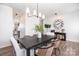 Dining room with a dark wood table, stylish lighting, and modern decor at 1624 Savory Ln, Charlotte, NC 28216