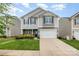 Charming two-story home with stone accents, a well-manicured lawn, and a two-car garage at 1624 Savory Ln, Charlotte, NC 28216