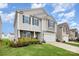 Charming two-story home features manicured lawn, stone accents, and an attached two-car garage at 1624 Savory Ln, Charlotte, NC 28216