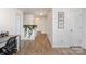 Bright hallway with art, desk, and indoor plants creates a welcoming and stylish transition between rooms at 1624 Savory Ln, Charlotte, NC 28216