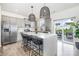 Modern kitchen boasts stainless steel appliances, a center island with seating, and stylish pendant lighting at 1624 Savory Ln, Charlotte, NC 28216