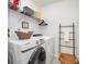 Functional laundry room with modern washer and dryer, storage shelves, and stylish decor for efficient chores at 1624 Savory Ln, Charlotte, NC 28216