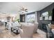 Stylish living room with a fireplace, neutral furniture, and ample natural light at 1624 Savory Ln, Charlotte, NC 28216